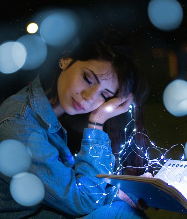 Woman in a peaceful meditation pose with an icy blue light glow.